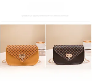 Detail of yellow and coffee crossbody bags with geometric texture and gold metal clasp