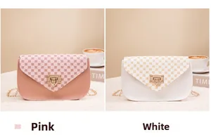 Detail of floral printed envelope chain bags in pink and white with gold metal clasp
