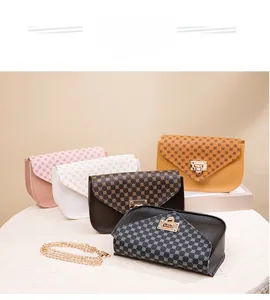 Detail showing various colors of small crossbody bags with vintage geometric patterns