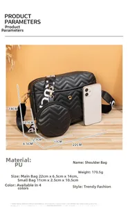 Detail of black wave quilted crossbody bag set with lettered strap and round charm