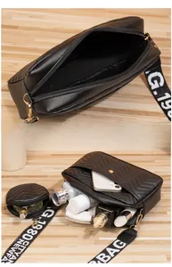 Detail of black V-quilted crossbody bag showing interior capacity and mini round purse