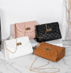 Detailed view of quilted faux leather crossbody bags in pink, black, white, and brown colors