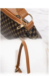 Close-up of high-polish gold hardware and textured leather handle on vintage handbag