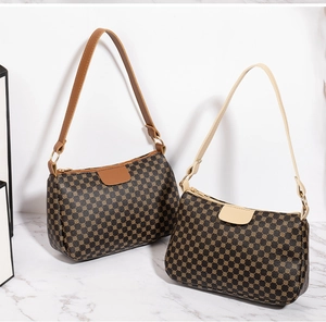 Detail of vintage patterned shoulder bags with contrasting straps and gold-tone hardware