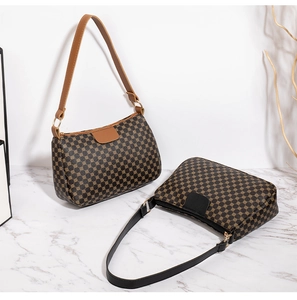 Detail of classic printed baguette bags in brown and black with geometric patterns