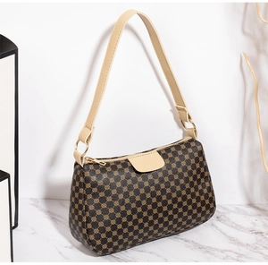Detail of printed crossbody bag showing dark brown retro geometric patterns and gold hardware