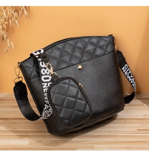 Détail du sac seau noir matelassé avec large bandoulière et mini porte-monnaie rond