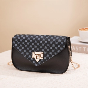 Women's black leather crossbody bag with clover print flap and gold chain strap
