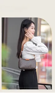 Close-up of a brown printed leather shoulder bag with a stylish vintage flap closure
