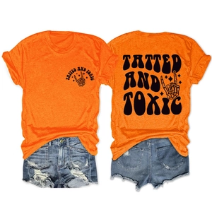 Front and back view of orange Tatted and Toxic t-shirt with ripped denim shorts set