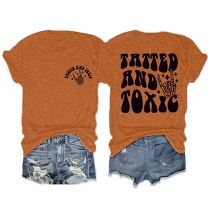 Detail of orange cotton T-shirt featuring Gothic text and skeleton hand graphic print