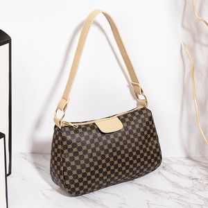 Classic printed crossbody bag with vintage pattern and cream shoulder strap on marble base