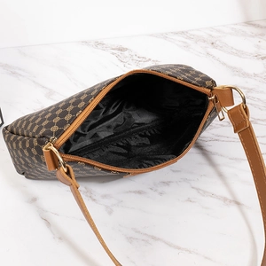 Brown floral printed crossbody bag with golden zipper and spacious black fabric interior