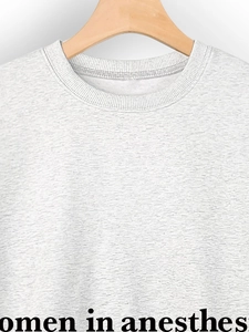 Macro view of grey round neck sweatshirt showing textured fabric and anesthesiology print