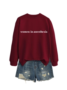 Detail of burgundy crewneck sweatshirt with white women in anesthesia print and denim shorts