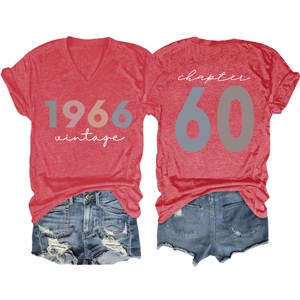 Flat lay of vintage 1966 women's V-neck T-shirt and denim shorts set for 60th birthday