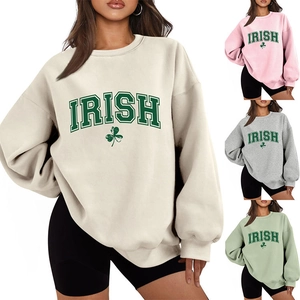 Close-up detail of oversized Irish shamrock sweatshirt with ribbed cuffs and soft cotton texture