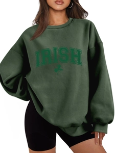 Detail of oversized dark green Irish clover sweatshirt with ribbed cuffs and neckline