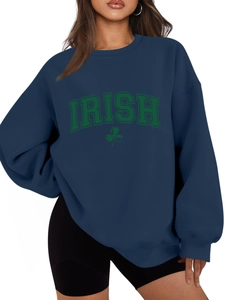 Detail of navy sweatshirt featuring green Irish clover print and ribbed cuffs
