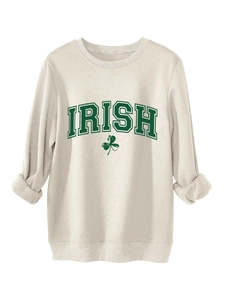 Detail of Irish shamrock print on cream oversized fleece sweatshirt for women