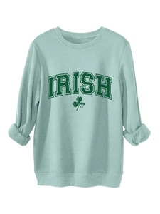 Close-up of ribbed cuffs and Irish shamrock print on thick mint green sweatshirt