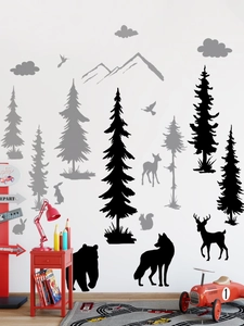 Detail of Nordic forest animal wall decals featuring pine trees and bear silhouettes