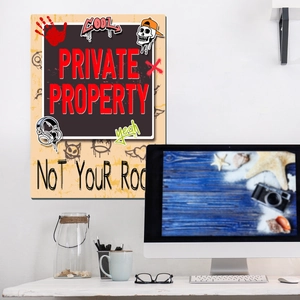 Macro shot of a graffiti style wall sign featuring Private Property and Not Your Room text