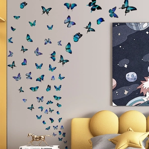 3D butterfly wall decals in blue hues arranged in spiral pattern on grey living room wall