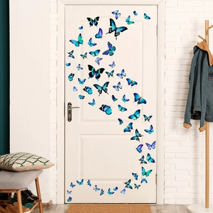 Detailed view of blue 3D butterfly wall stickers with realistic textures on a white door