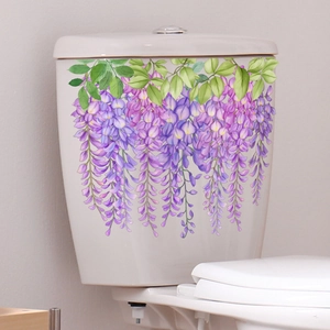 Detail of violet wisteria floral wall stickers on a white bathroom toilet tank surface