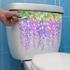Violet wisteria vine floral wall sticker applied to white toilet tank for bathroom decor
