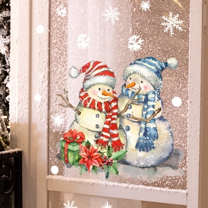 Detailed view of watercolor snowman window stickers with gift boxes and white snowflakes