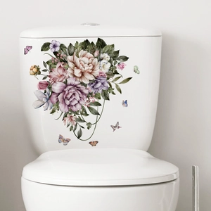 Close-up of floral toilet sticker with purple flowers and butterflies on white ceramic