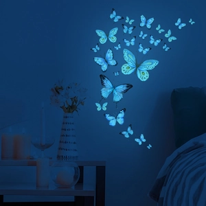 Luminous blue butterfly wall stickers glowing in a dark bedroom setting for home decor