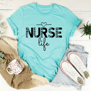 Flat lay of Nurse Life t-shirt with leopard print text and casual denim shorts