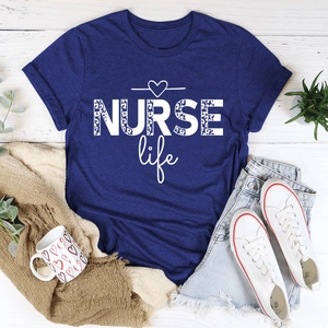 Detail view of NURSE Life leopard print t-shirt on rustic wood with casual lifestyle items