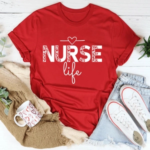 Flat lay of red cotton t-shirt with Nurse Life leopard print graphic and accessories