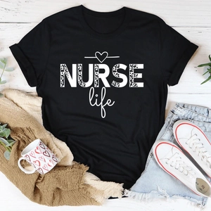 Flat lay of black NURSE Life t-shirt with leopard print text and lifestyle accessories