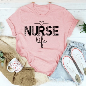 Flat lay of pink NURSE life T-shirt with leopard print text and denim shorts