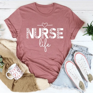 Flat lay of a dusty pink NURSE life t-shirt with leopard print text and white heart