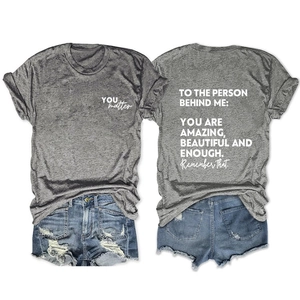 Flat lay of gray T-shirt with 'YOU matter' print and distressed denim shorts set