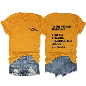 Detailed back view of ginger t-shirt featuring black inspirational printed text and graphics