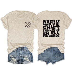 Oatmeal t-shirt with heart graphic and back slogan paired with denim shorts