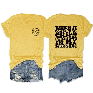 Flat lay of yellow cotton T-shirt with black letter print and ripped denim shorts