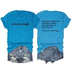 Detail of light blue short sleeve T-shirt and denim shorts with 'you are enough' print