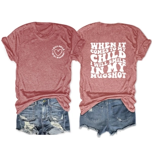 Detailed front and back view of brick red t-shirt with slogan and ripped denim shorts