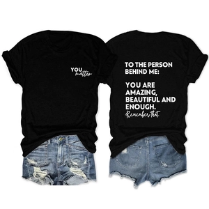 Close-up of inspirational text print on black cotton T-shirt with denim shorts set
