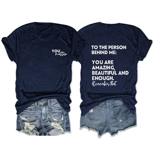 Navy t-shirt with back inspirational print and distressed denim shorts flat lay