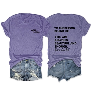 Detail view of purple cotton t-shirt with TO THE PERSON print and motivational text
