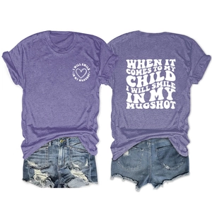 Flat lay of purple crewneck T-shirt with white slogan print and frayed denim shorts